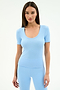 A woman faces forward against a white background, wearing the SPLITS59 Ashby Rib Short Sleeve in Skylight, a light blue top with short sleeves and scoop neck, paired with matching fitted pants made from a soft modal spandex blend.