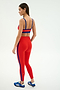 A woman models the SPLITS59 Clare High Waist Rigor 7/8 leggings in Lotus Red/Cobalt, featuring a performance fabric and bold blue stripes—perfect for your next workout.