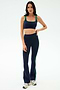 Woman wears the SPLITS59 Raquel High Waist Flared Legging in Indigo/Grass, featuring green trim and 4-way stretch—ideal for your next workout.