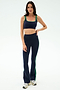 Woman wears the SPLITS59 Raquel High Waist Flared Legging in Indigo/Grass, featuring green trim and 4-way stretch—ideal for your next workout.