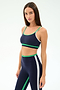 A woman models the SPLITS59 Eva Rigor Double Strap Bra in Indigo/Spearmint, paired with matching high-waisted leggings, against a plain white background.