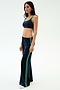 A woman in profile wears the SPLITS59 Heritage Velour Pant in Indigo/Grass and a navy sports bra, standing against a plain white background.
