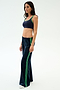 A woman in profile wears the SPLITS59 Heritage Velour Pant in Indigo/Grass and a navy sports bra, standing against a plain white background.