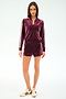 A woman wears the SPLITS59 Heritage Velour Bomber in Dark Cherry/White with matching shorts and white sneakers against a plain light background.
