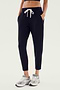 A person wearing the Reena Fleece 7/8 Sweatpant in Black by Splits59, paired with gray sneakers, epitomizes comfort and style.