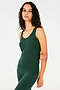 Side view of girl wearing a dark green tank top and dark green leggings