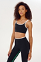 A woman wearing a Cait Rigor Bra in Black/White and matching leggings, designed for high impact workouts by SPLITS59.