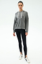 A person stands facing forward, wearing the SPLITS59 Joey Long Sleeve Hoodie in Medium Heather Grey, black spandex leggings, and white sneakers against a plain white background.
