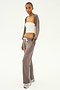 A person wearing a white tube top and a gray cardigan, paired with the SPLITS59 Raven Fleece Full Length Sweatpant in Lentil featuring white drawstrings, stands on a white background.