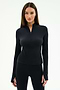 A woman wears the SPLITS59 Tess Rigor Half Zip Waist Length top in black with matching black leggings, standing against a plain light background.