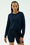 Wearing the SPLITS59 Brooks Fleece Long Sleeve Sweatshirt in Indigo, a person stands against a plain light background.
