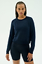 Wearing the SPLITS59 Brooks Fleece Long Sleeve Sweatshirt in Indigo, a person stands against a plain light background.