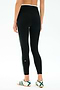 A person is shown from the back wearing SPLITS59 Sam High Waist Rigor 7/8 leggings in Black/Military with a green side stripe and white sneakers, featuring Rigor fabric for a run-tight fit, against a plain background.