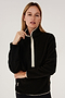 A woman wearing a SPLITS59 Libby Sherpa Half Zip in Black/Creme.