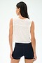 A woman stands with her back to the camera, wearing SPLITS59's Logan Mesh Tank With Stripe in White/Indigo and black athletic shorts—perfect breathable sportswear against a plain background.