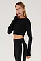 Side view of girl wearing black long sleeve crop top and black leggings with white stripe