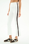 A person wears SPLITS59's Raquel High Waist Supplex Crop in White/Dark Chocolate—high-waisted white leggings with a dark chocolate side stripe—and black-and-white Nike sneakers, standing against a white background.
