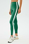 Against a plain backdrop, a person models SPLITS59's Clare High Waist Rigor 7/8 in Arugula/White with white sneakers. This high-performance style ensures both fashion and durability.
