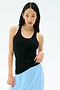A woman with long black hair wears the Splits59 Ashby Rib Tank in black with light blue pants, standing against a plain light background.