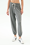 A person wearing SPLITS59 Andie Oversized Fleece Sweatpant in Medium Heather Grey and white sneakers, shown from midriff to feet against a plain background—made in Los Angeles and perfect for cool weather workouts.