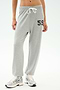 Model wears SPLITS59 Andie Oversized Fleece Varsity 59 Sweatpant in Heather Grey/59, featuring a drawstring and "59" on the left thigh, paired with white athletic shoes—perfect for cool weather workouts against a plain background.