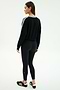 A woman faces slightly away from the camera on a white background, wearing the SPLITS59 Ellie Fleece V Neck Sweatshirt in black/white, paired with black leggings and black athletic shoes.