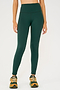 Front view of model wearing dark green high waist  leggings and orange shoes
