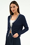 A woman stands against a white background wearing the SPLITS59 Bekah Knit Cardigan in indigo/white, crafted from soft rayon, over a white top and navy pleated skirt.