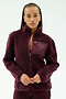 A person wearing the SPLITS59 Harris Sherpa Jacket in Dark Cherry, made from soft 100% polyester with a zippered chest pocket, stands against a plain light background.