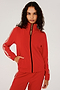 Front view of girl wearing red zip jacket that stops under chin with two white stripes down the side and a black zipper in the front with a red sweatpants