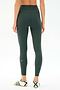 Person faces away, wearing SPLITS59 Airweight Rib High Waist 7/8 leggings in Military and white sneakers with green detail, against a plain light background.