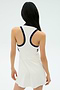 A person with long dark hair, seen from behind, is wearing the SPLITS59 Austin Rigor Dress in White/Indigo with a racerback design.