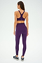 A person is wearing the Ella Airweight Bra in Black Currant/Indigo from SPLITS59 with matching leggings, standing with their back facing the camera, ready for a session of hot yoga.
