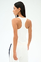 A person with long dark hair wears the SPLITS59 Mel Airweight Lite Tank in white, paired with white pants, standing facing away against a plain background.
