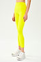 Front view of model wearing bright yellow high waist leggings and white shoes