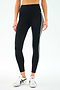 Someone in SPLITS59 Ella High Waist Airweight 7/8 leggings in Black/White with side stripes and white sneakers stands against a light background—ideal for hot yoga or everyday wear.
