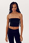 A person with long braided hair is wearing a black SPLITS59 Hazel Airweight Crop Bandeau - Black and black spandex pants, standing against a plain white background.