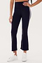 Person wearing SPLITS59 Raquel High Waist Crop - Black/White, made from 88% Nylon and Spandex blend, paired with white sneakers, standing against a plain white background.