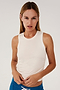 A woman in a SPLITS59 Frida Jersey Tank - White, perfect for gym workouts, and blue sweatpants.