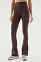 Person wearing SPLITS59 Raquel High Waist Flared Legging in Dark Chocolate with beige sneakers, standing against a plain background.