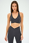 A woman wears the SPLITS59 MIA RIGOR BRA and matching high-waisted leggings, crafted from soft nylon spandex, standing against a plain light background.