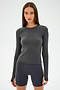 Against a light gray background, a person wears the SPLITS59 Airweight Lite LS Waist Length in Graphite with matching shorts, ideal for quick-dry gym workouts.