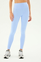 A person wearing SPLITS59 Clare High Waist Rigor 7/8 in Skylight/White and grey sneakers stands against a plain white background.