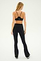 Person wearing a black sports bra and Raquel High Waist Flared Legging in Black/White from SPLITS59, made from 4-way stretch supplex fabric, standing and facing away in a neutral background.