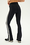 Person wearing SPLITS59 Raquel High Waist Flared Legging in Black/White with white side stripes, a black cropped top, and black sneakers.