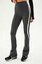 A person wearing SPLITS59's Raquel High Waist Flared Legging in Heather Grey with white and black accents, paired with black and white sneakers and a black long-sleeve top.