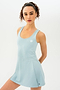 A woman is posing in a Martina Rigor Dress - Teal designed by SPLITS59 for court sports.