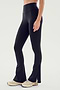 A person wearing the SPLITS59 Raquel High Waist Flare w/ Split Hem - Black leggings and white sneakers stands against a plain background.