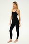 Person standing barefoot wearing the SPLITS59 Airweight Jumpsuit in black, looking slightly to the left, on a plain light background that's perfect for hot yoga.