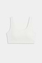 The SPLITS59 Airweight Rib Bra in white features wide straps and a scoop neckline, crafted from ribbed airweight fabric for comfort—ideal for hot yoga. Shown laid flat on a plain light background.